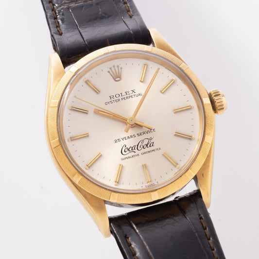 Rolex Oyster -Perpetual  silver "25 years Coca Cola service " logo dial   in 18 k yellow gold  with original double punched papers ref 1003